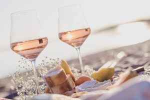 Bicchieri di vino rosato sulla spiaggia per pic nic